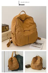 Vues détaillées d'un sac à dos en toile marron vintage à grande capacité et double fermeture