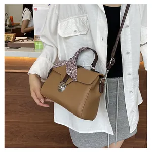 Brown lychee leather tote bag with decorative vintage scarf and silver twist lock