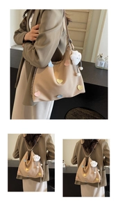 Detail showing beige canvas tote with macaron heart patches and cloud plush charm