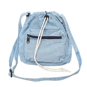 Light blue denim drawstring bucket bag with adjustable shoulder strap and zip front pocket