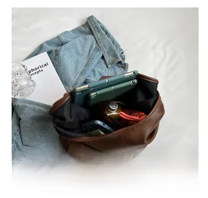 Detail view of large brown pebble leather tote bag showing spacious inner storage capacity