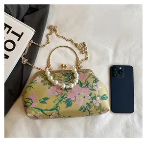 Detailed size comparison of green jacquard evening bag with cherry blossom embroidery