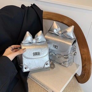 Mini silver metallic leather crossbody bag with oversized bow and chain strap
