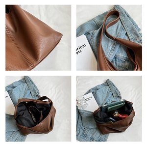 Detail of brown litchi leather tote bag with large capacity and wide shoulder strap