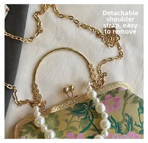 Detail of vintage floral jacquard bag with pearl handle and detachable gold chain strap