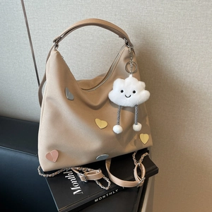 Large beige canvas tote bag with colorful heart patches and cloud plush pendant