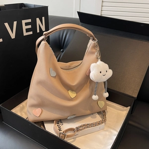 Chic beige canvas tote bag with heart patches and cloud charm in a premium black gift box