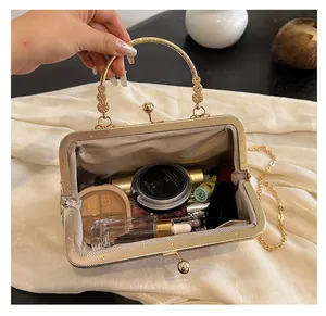 Detailed view of an open vintage clasp bag showing spacious interior with cosmetics