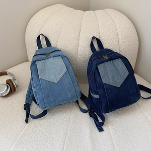 Women's casual denim mini backpack in light and dark blue wash with front pocket