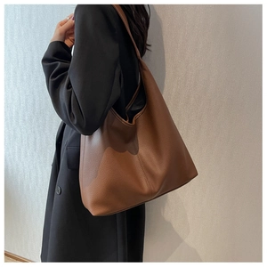 Brown lychee grain large tote bag showing soft leather texture and wide shoulder strap