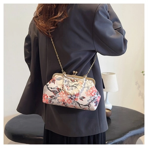 Retro floral shell bag worn crossbody with pearl handle and golden chain detail
