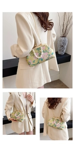 Detail of vintage floral kiss-lock bag with pearl handle and golden chain strap