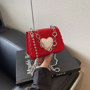 Mini red leather heart bag with wavy edge and silver floral chain strap for women