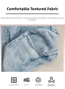 Detailed macro view of light blue denim fabric texture and brown reinforced stitching