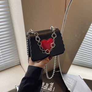 Mini black crossbody bag with red heart detail and silver chain strap for summer 2024