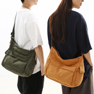 Minimalist canvas messenger bags in olive green and mustard yellow with wide straps