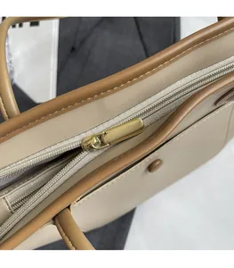 Close-up of smooth metal zipper and herringbone lining on this large tote bag