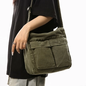 Army green canvas messenger bag featuring large double front pockets and adjustable strap