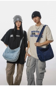 Detailed view of vintage washed denim messenger bags in light and dark blue styles