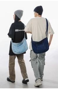 Deep and light blue washed denim crossbody bags shown on models for size comparison