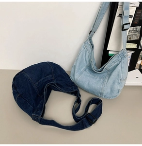 Detail of dark and light blue denim tote bags with adjustable straps for casual use