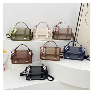 Staircase display of woven crossbody bags with decorative scarves in seven assorted colors