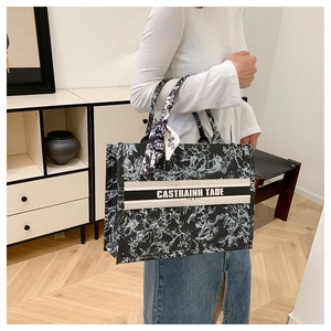 Close-up detail of vintage floral canvas tote bag with black and white Toile de Jouy pattern