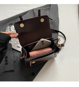 Interior view of vintage brown crossbody bag showing spacious storage for phone and wallet