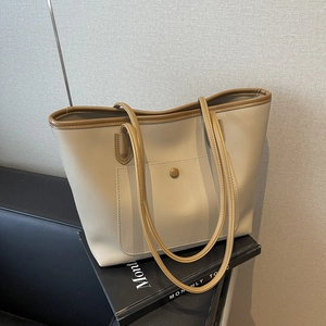 Large capacity beige tote bag with brown trim and front pocket for daily commute