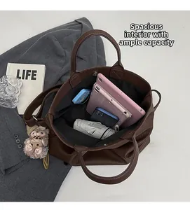 Top view of spacious interior of brown leather tote bag with tablet and daily items