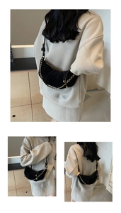 Detail of matte black croissant bag with premium suede texture and gold chain strap