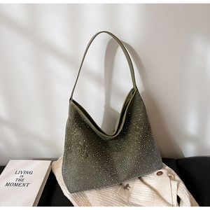 Détail d'un sac hobo vert olive avec cristaux argentés étincelants sur tissu doux