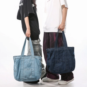 Large denim tote bags in light and dark blue with decorative stitching and front pockets