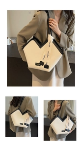 Detail view of large tote bag with V-shaped opening and vertical striped texture