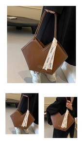 Close-up of brown tote bag with V-shaped opening, vertical stripes and silk ribbon detail