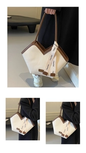 Detail of V-neck opening tote bag with striped texture and premium brown leather trim