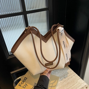 Chic beige pleated tote bag with brown faux leather trim and wide canvas shoulder strap