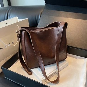 Sac seau vintage en cuir marron avec large bandoulière dans un coffret cadeau chic