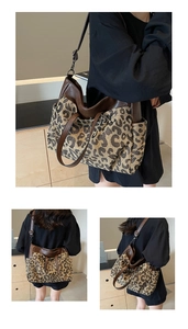 Close-up of large leopard print tote bag with brown leather handles and shoulder strap
