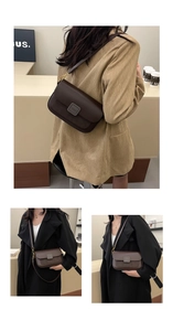 Detail of dark brown leather crossbody bag with flap and metal logo on a stylish outfit