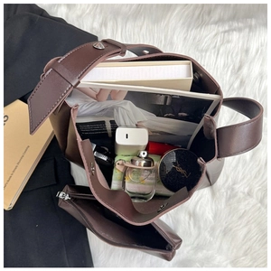 Deep brown leather tote bag interior showing spacious capacity and matching pouch