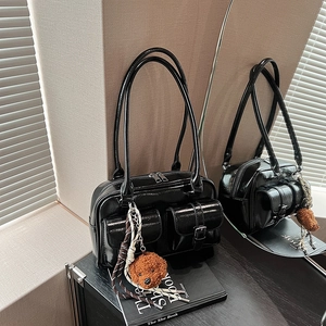 Black glossy vintage shoulder bag with front buckle pockets and plush dog charm