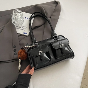 Glossy black patent leather shoulder bag with silver buckles and a cute bear charm