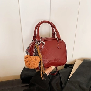 Retro dark red mini handbag in glossy PU leather with bear pendant and woven charm