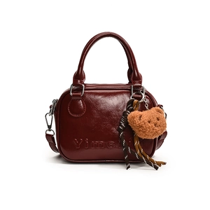 Minimalist burgundy PU leather Boston bag with plush bear charm and adjustable strap