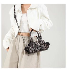 Detail of leopard print faux leather bag with vintage buckles and adjustable strap