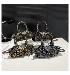 Detail of mini Boston bags in leopard and houndstooth patterns with rivet buckle accents