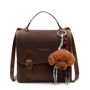 Brown vintage faux leather handbag with cute teddy bear charm and gold lettering details