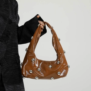 Brown patent leather handbag with silver stud details and high gloss finish