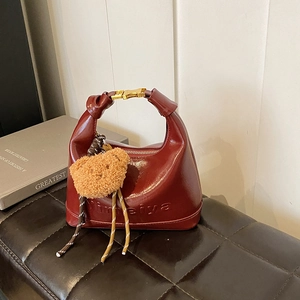Deep red leather hobo bag with gold buckle and cute brown bear pendant for women